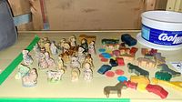 Full overview of figurines, bingo chips, and wooden toys grouped on table