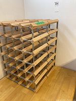 Photo of one wooden and metal wine rack showing multiple bottle slots in a grid pattern