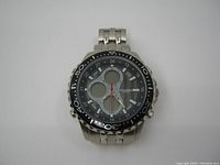 Front view of Elgin MZB quartz watch displaying dial with multiple circular digital display windows and analog hands, black bezel with white markings.