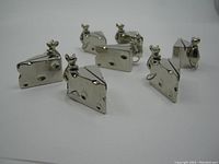 Seven vintage silver-tone metal place holders shaped as mice sitting on wedges of cheese, displayed on plain white background.