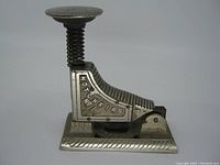 Side view of stapler showing 'HOTCHKISS No 1' embossed on its body and base's rope pattern