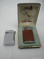 Bentley lighter in original box with Sim Luxe lighter beside it, showing front and top detail