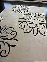 Angled shot showing central floral scroll design