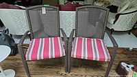 Front view of two matching chairs side by side showing overall design and cushions