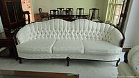 Full front view of the scalloped back sofa showing entire frame and upholstery