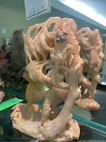 Front and left-side view showing horses and tree canopy