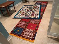 Both area rugs displayed on tiled floor showing size and pattern contrast between small mat and runner