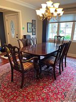 Overview of dining table with two captain chairs and four side chairs