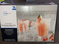 Front of box showing 16 piece Cross Plains drinking glass set with image of glasses filled with beverages.