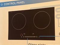 Control panel of the induction cooker showing two circular burners and touch control buttons with LED display