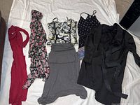 All six clothing items laid out on a white background showing dresses, robes, and coat
