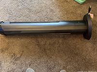 Side view of tall, black tower fan showing length and base.