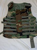 Full frontal photo of camouflage military vest showing front solid panel and multiple horizontal adjustable straps on sides