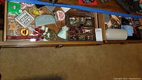 View of two opened drawers showing assorted watches, costume jewelry, pins, collar stays, sachets, gloves and baseball cards.
