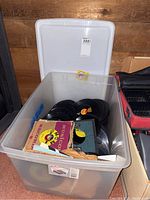 Plastic tote filled with vinyl 45 RPM records, also shows partial record covers including a MUGGON RECORDS sleeve