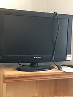Front view of black 26 inch Electron TV/DVD combo on stand with power cord visible.