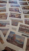 Photo showing a spread of multiple Canadian historical prints from the portfolio, highlighting the vivid illustrations and varied scenes.