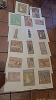 Full layout of 16 Maurice Prendergast monotype art prints laid out on a floor, showing a variety of impressionistic figures and social scenes.