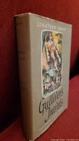 Front and spine view of the 1945 edition Gulliver's Travels hardcover with original dust jacket featuring mid-century modern illustration