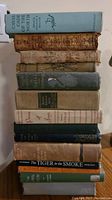 Stack of 10 old books showing titles and spine details including George Eliot and others