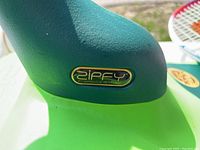 Close-up of Zipfy logo on the mini luge green handle attachment