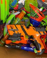Top view showing orange and black Hammer Head blaster with multiple Nerf accessories including a basketball hoop and dart pump.