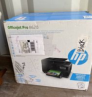 Box showing HP Officejet Pro 8620 printer with packaging details and seller markings.