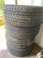 Four stacked tires with visible tread wear