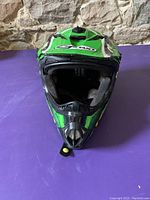 Front view of youth motocross helmet showing air vents and chin guard.