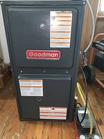 Front view of furnace cabinet with Goodman logo