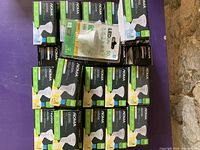 Full lot view showing numerous boxes of NOMA LED soft white bulbs stacked with one LED Life branded bulb pack on top