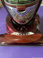 Front base and top part of Shark Euro-Pro X vacuum cleaner showing the power dial, power button, and chrome accents on a red body.
