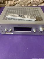 Front view of Sony STR-DG800 AV receiver with remote on top showing control knobs and digital display