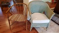 Both chairs side by side on hardwood floor, green faux wicker armchair on right with white cushion, bentwood chair on left with woven seat upholstery