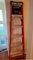Full view of Lite 6ft step ladder positioned against wall.