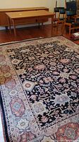 Full view of wool rug on hardwood floor with furniture