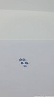 Five pear-cut blue sapphires on white background, overview