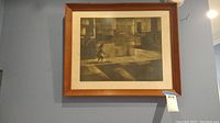 Front view of framed sepia print showing girl with hoop against urban backdrop