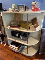 Full view of the 4-tier painted wood shelf with metal vertical supports, showing shelving contents removed and condition of scratches on shelves.