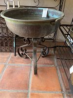 Front view of planter bowl on stand showing overall form