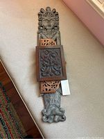 Top view of all three wood carvings laid out including the Asian inspired woman and two decorative panels, showing size and detail
