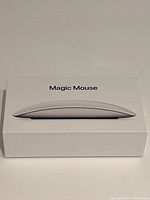 Side view of the Magic Mouse box with image of the mouse on top.