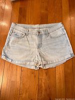 Front view of the faded light blue Old Navy jean shorts showing cuffs, front pockets, button, and zip fly.