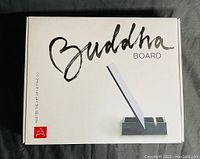 Original Buddha Board packaging featuring brush and stand image on box.