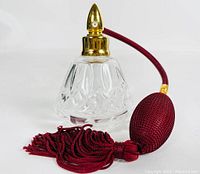 Photo showing side view of Waterford crystal atomiser with gold-tone top and burgundy fabric bulb and tassel.
