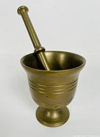 Side view of the mortar with pestle inside showing details and size proportions
