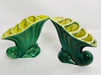 Side view of matching vases showing shape and two-tone green glaze