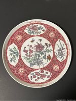 Top view of the porcelain tray showing detailed floral and butterfly designs in red and white.
