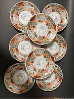 Top view of eight stacked Imari porcelain plates showing the detailed pattern and colors.