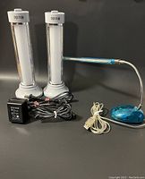 Photo of all LED lights showing two vertical lamps, a flexible blue desk lamp, power adapter, and USB cable.